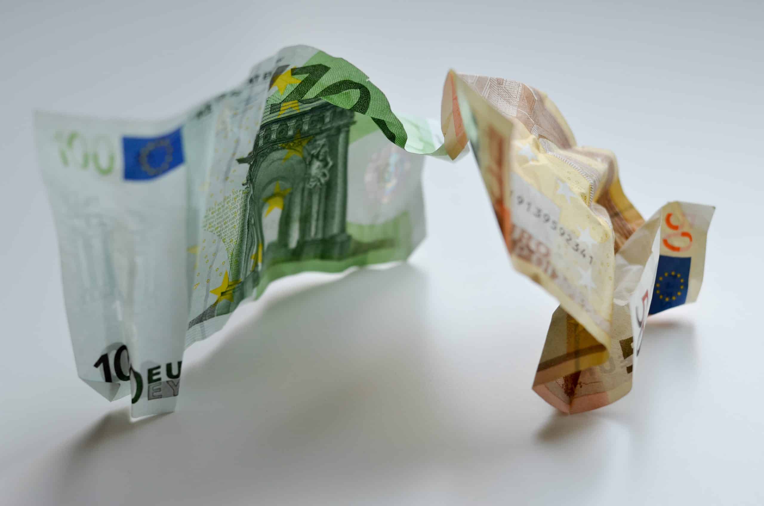 50-and-100-euro-notes-shaking-hands-LLMDJBK